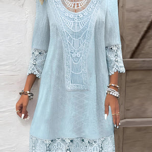 Light blue bohemian crochet V-neck lace dress featuring a delicate lace pattern, designed as a women's beach cover-up. The dress highlights the shoulders and waist with its flowing sleeves and intricate textile details.