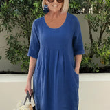 Light blue linen knee-length dress with 3/4 sleeves, designed for a casual and breathable fit, displayed on a model.