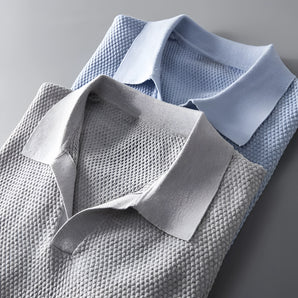 Light blue men's polo shirt with a grey collar, featuring short sleeves and breathable fabric ideal for business casual attire.