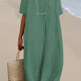 Light blue oversized linen beach dress displayed on a mannequin, featuring a V-neck design and loose sleeves, suitable for a summer fashion look.