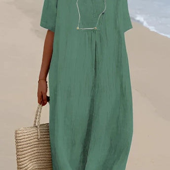Light blue oversized linen beach dress displayed on a mannequin, featuring a V-neck design and loose sleeves, suitable for a summer fashion look.