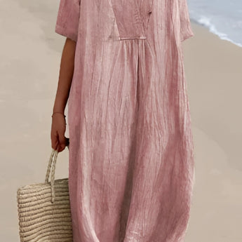 Pink oversized linen beach dress with a V-neck design, featuring short sleeves and a relaxed fit, suitable for summer outings.