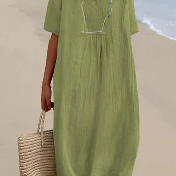 Light blue oversized linen beach dress featuring a V-neck design with short sleeves, tailored for summer fashion.