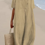 Light blue oversized linen beach dress with a V-neck design, featuring short sleeves and a relaxed fit, suitable for summer fashion. The dress is displayed with a focus on the shoulder and neckline details, emphasizing its casual elegance.