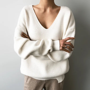 Light blue oversized V-neck knit sweater featuring a cozy, loose fit, showcased on a mannequin to highlight the shoulder, neckline, and sleeve details.