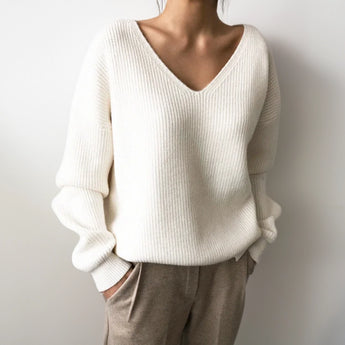Light blue oversized V-neck knit sweater with a casual chic design, featuring long sleeves and a relaxed fit ideal for a stylish and comfortable look.