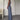 Light blue sleeveless high-waist backless formal jumpsuit displayed on a mannequin, showcasing its elegant design with a fitted waist and flowing pant legs.