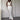 Light blue sleeveless high-waist backless formal jumpsuit displayed on a mannequin, highlighting the elegant design with tailored waist, open back, and flowing wide-leg pants.