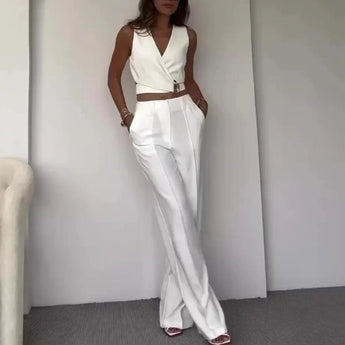 Light blue sleeveless high-waist backless formal jumpsuit displayed on a mannequin, highlighting the elegant design with tailored waist, open back, and flowing wide-leg pants.