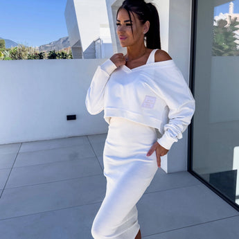 
A model wearing a light blue sleeveless midi dress, ideal for chic summer fashion, standing against a bright sky. The dress features a fitted waist and is styled in an elegant formal wear look, emphasizing a fashionable and sophisticated design.