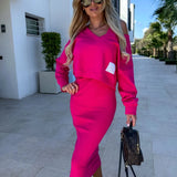A woman wearing a fuchsia sleeveless midi dress paired with stylish sunglasses, showcasing a chic summer fashion outfit.