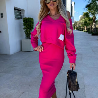A woman wearing a fuchsia sleeveless midi dress paired with stylish sunglasses, showcasing a chic summer fashion outfit.