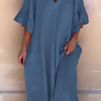 A model wearing a dark blue V-neck ruffle sleeve loose fit summer dress made of cotton, suitable for plus sizes, displayed in a 3XL size.