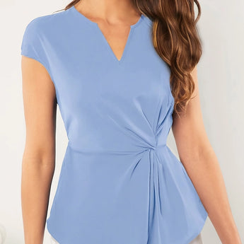 Woman wearing a light blue V-neck twist-front blouse with short sleeves, showing shoulders and arms.