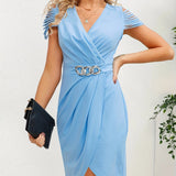 Light blue v-neck wrap dress with ruffle sleeves and a silver chain belt.
