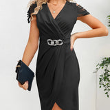 A woman wearing a light blue v-neck wrap dress with ruffle sleeves and a silver chain belt, standing in a stylish pose.