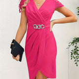 Woman wearing light blue V-neck wrap dress with ruffle sleeves and a silver chain belt