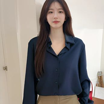 Light blue women's blouse with long sleeves and a classic collar, suitable for minimalist, casual, and office wear.