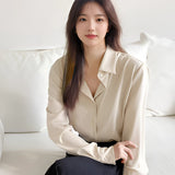 Light blue women's blouse designed for a minimalist, casual, and office wear look, featuring a comfortable fit with a collar and long sleeves.