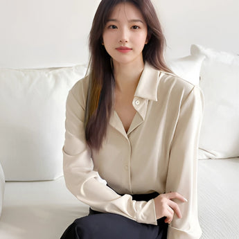 Light blue women's blouse designed for a minimalist, casual, and office wear look, featuring a comfortable fit with a collar and long sleeves.