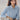 Light blue women's blouse with a minimalist design, featuring a collar and long sleeves, suitable for casual and office wear.