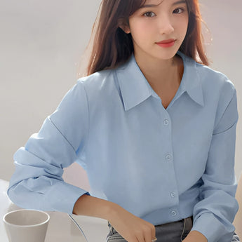 Light blue women's blouse with a minimalist design, featuring a collar and long sleeves, suitable for casual and office wear.