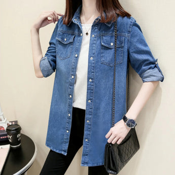 Light blue denim shirt dress for women with an oversized, casual tunic style, featuring long sleeves and a button-down front.