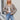 Light brown women's casual knit sweater in a relaxed fit, featuring ribbed knit detailing with long sleeves, worn by a model paired with jeans.