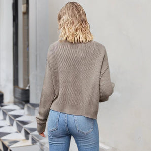 Light brown women's casual knit sweater with a relaxed fit and ribbed texture, featuring long sleeves and a round neckline.