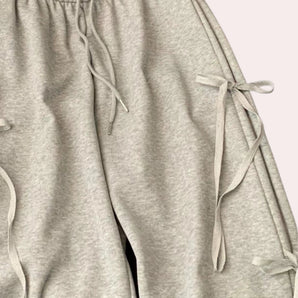 Light gray joggers with an adjustable waistband made from soft fabric.