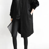 Light gray women's oversized double-breasted trench coat with a classic collar and long sleeves.