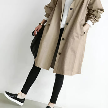 Light gray women's oversized double-breasted trench coat in beige, featuring a classic collar, long sleeves, and a knee-length design, ideal for fashion-forward style.