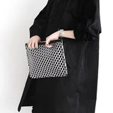 
A black oversized double-breasted trench coat for women in size 3XL, featuring a stylish collar and long sleeves, worn by a model shown from the waist up.