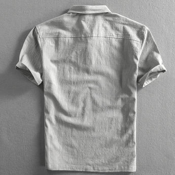 Light grey men's short sleeve linen dress shirt with mandarin collar and buttons, breathable fabric.