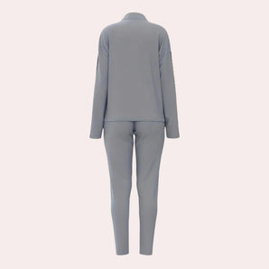 Light grey women's activewear set featuring high waist leggings and a fitted sports top, designed for comfort and style during workouts.