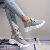 Light grey women's fashion sneakers with breathable mesh and cushioned sole, designed for walking and casual wear.