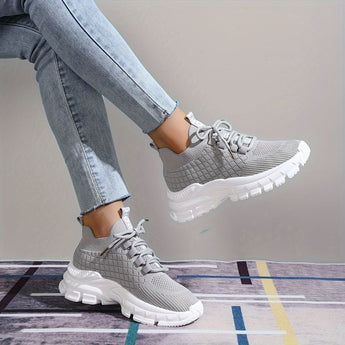 Light grey women's fashion sneakers with breathable mesh and cushioned sole, designed for walking and casual wear.