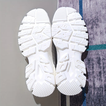 Light grey women's fashion sneakers with breathable mesh upper and cushioned sole.