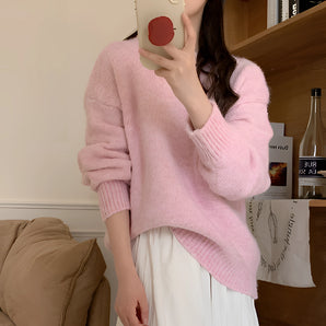 Light pink fluffy pullover sweater with a cozy texture, featuring a relaxed fit and long sleeves, suitable for casual winter wear.