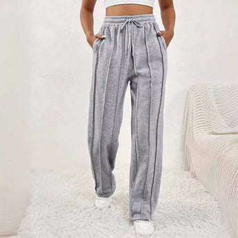 Light pink high-waist joggers for women, featuring a stylish and comfortable design with an elastic waistband and tapered legs.