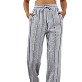 Light pink high-waist joggers for women, showcasing a stylish and comfortable design with an elastic waistband and a relaxed fit.