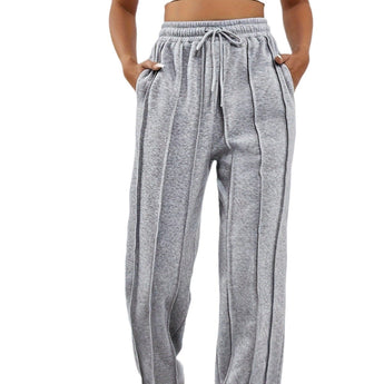 Light pink high-waist joggers for women, showcasing a stylish and comfortable design with an elastic waistband and a relaxed fit.