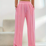 Women's light pink high-waist joggers featuring a stylish and comfortable design, highlighting elements like the waistband and knee area, with a focus on a soft, peachy pink color.
