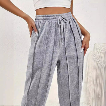 Light pink high-waist joggers for women, featuring a stylish and comfortable design with a snug waist fit.