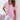 Woman wearing a light pink V-neck blouse in size 3XL, showing off its breathable and stylish features for a casual summer look.