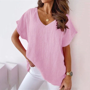 Woman wearing a light pink V-neck blouse in size 3XL, showing off its breathable and stylish features for a casual summer look.
