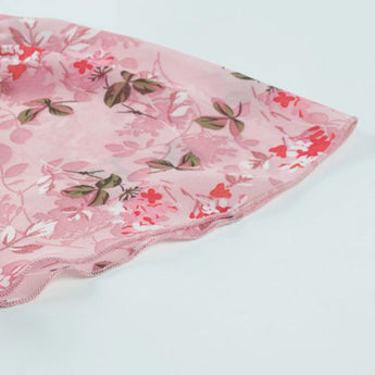 Light pink floral blouse with a V-neck design, featuring a delicate flower print and tie at the waist.