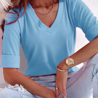 A light pink V-neck ribbed sweater for women, featuring long sleeves and a casual spring fashion design.