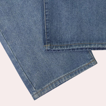 Light-wash high-waist denim jeans in a faded blue color with a five-pocket design, showcasing the classic denim texture and detailed stitching.
