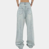Light-wash high-waisted baggy jeans with elastic cuffs, showcasing a relaxed fit through the legs and made from denim fabric in a light blue shade.